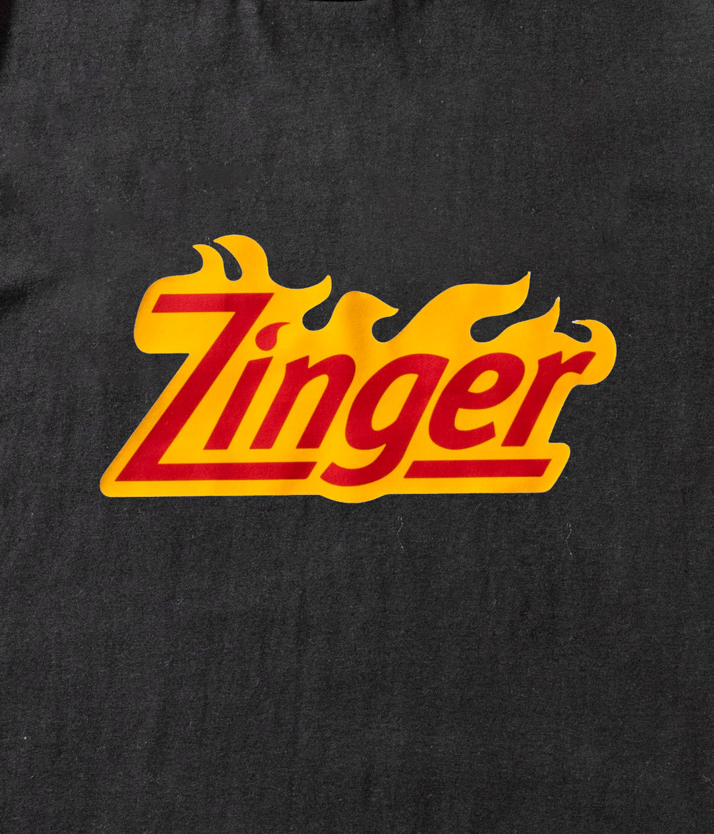 close up view of 'Zinger' branded logo on black material