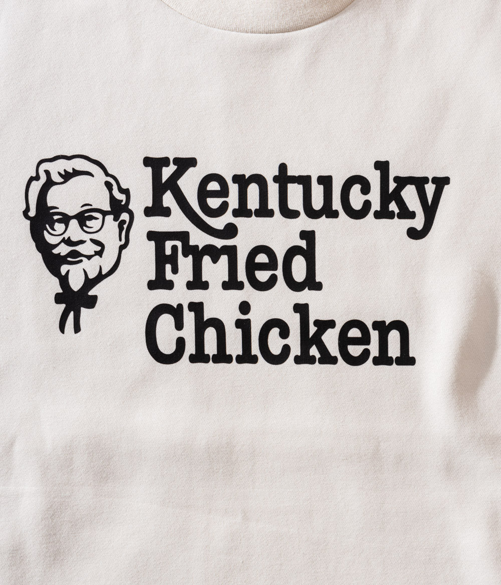Close up of off-white KFC crew neck jumper with black kentucky fried chicken message
