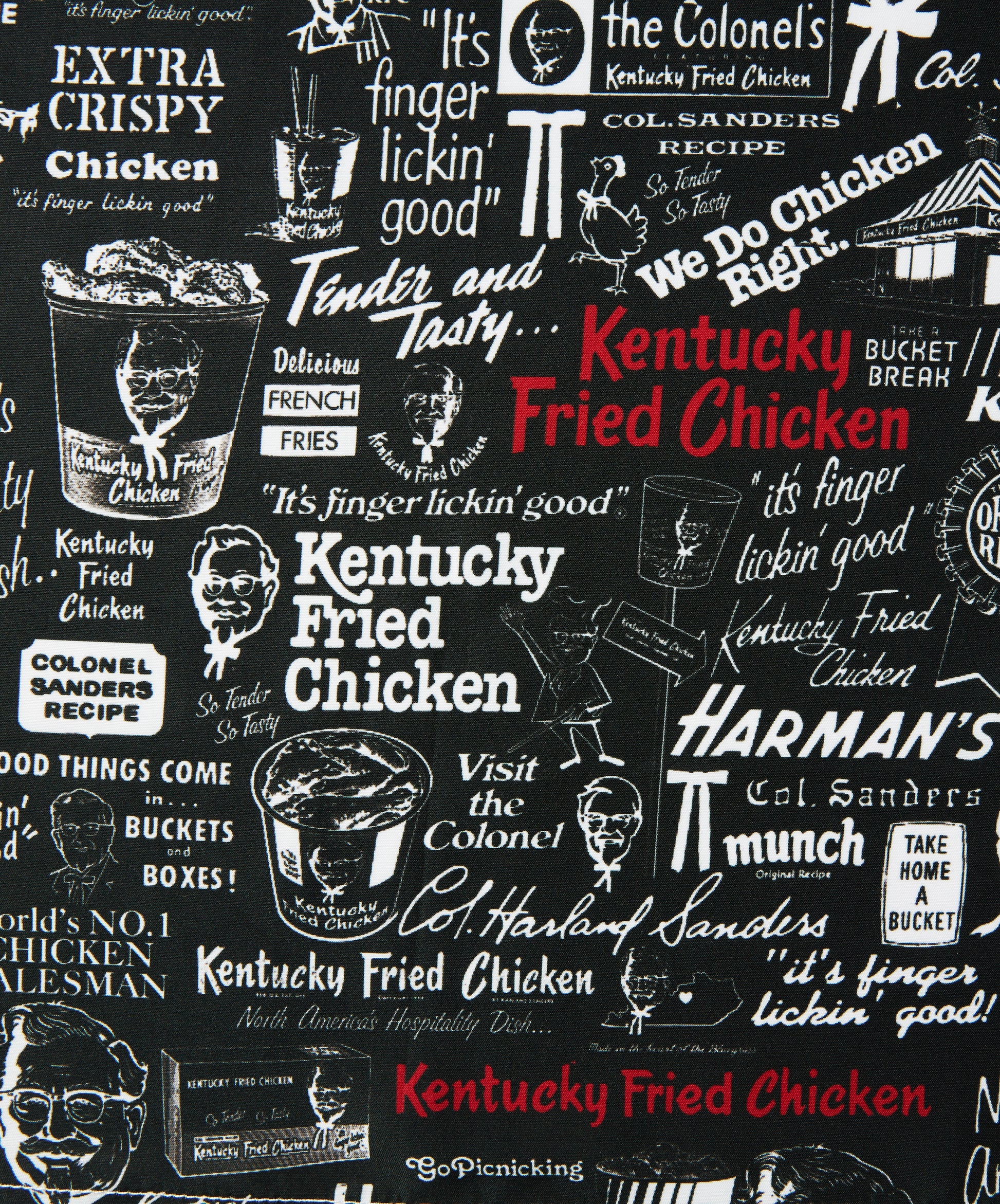 close up of KFC faded black patterned shirt with KFC logos and messaging