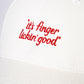 close up view of KFC off-white cap with red message of 'it's finger lickin good' and KFC logo