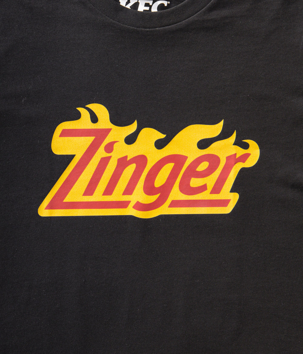 close up view of KFC black tee shirt with 'Zinger' branding 