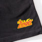 zoomed in view of KFC black shorts with 'Zinger' logo