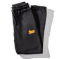 folded black track pants with KFC Zinger logo