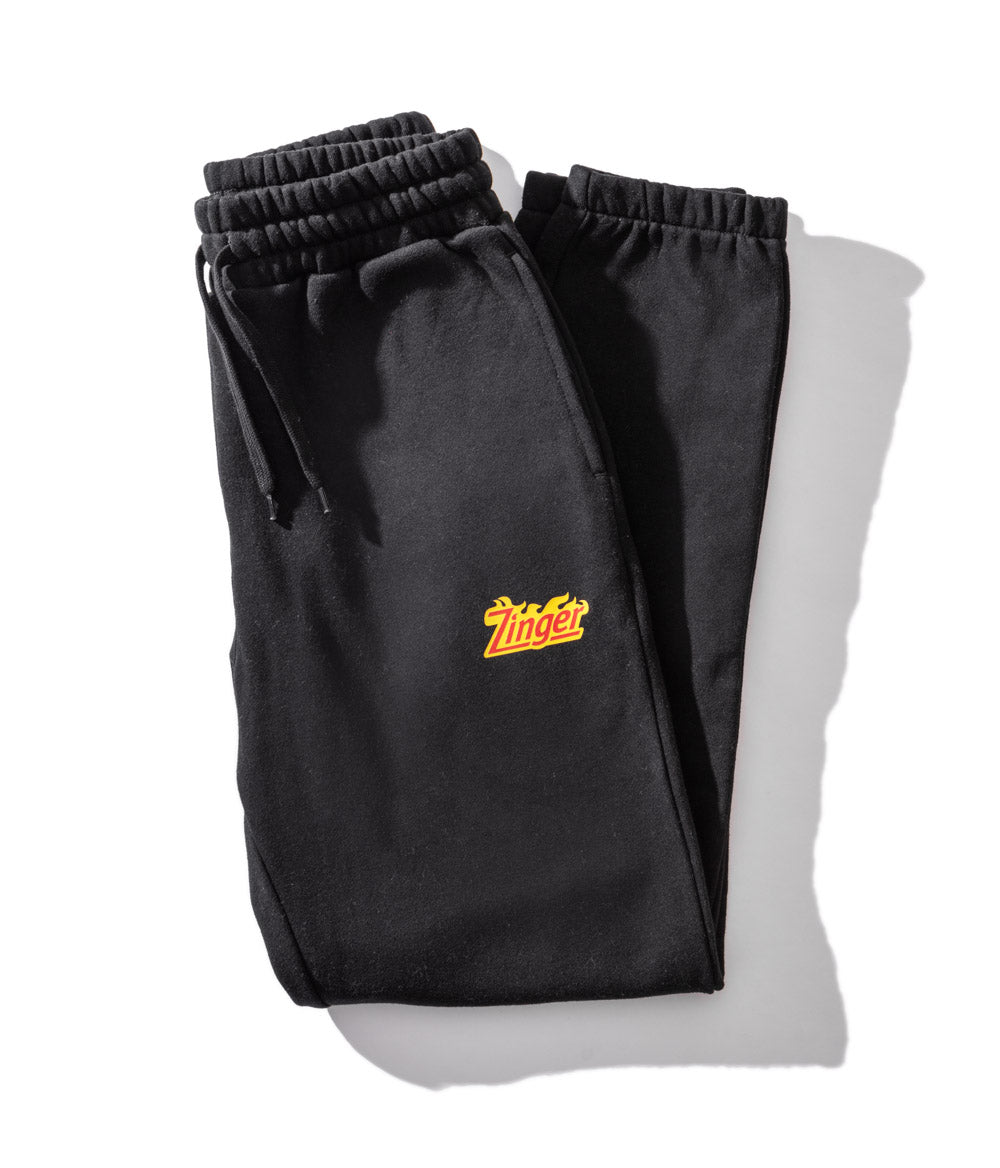 folded black track pants with KFC Zinger logo